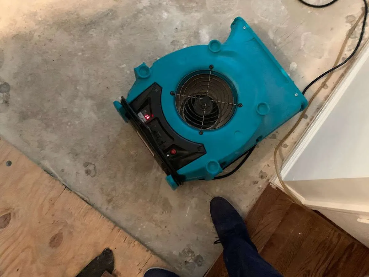 Air mover drying subfloor during Commercial Water Damage Restoration in Aventura